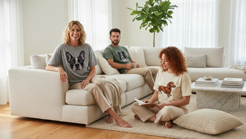 Three people wearing custom embroidered dog shirts with different dog breeds in a bright modern home