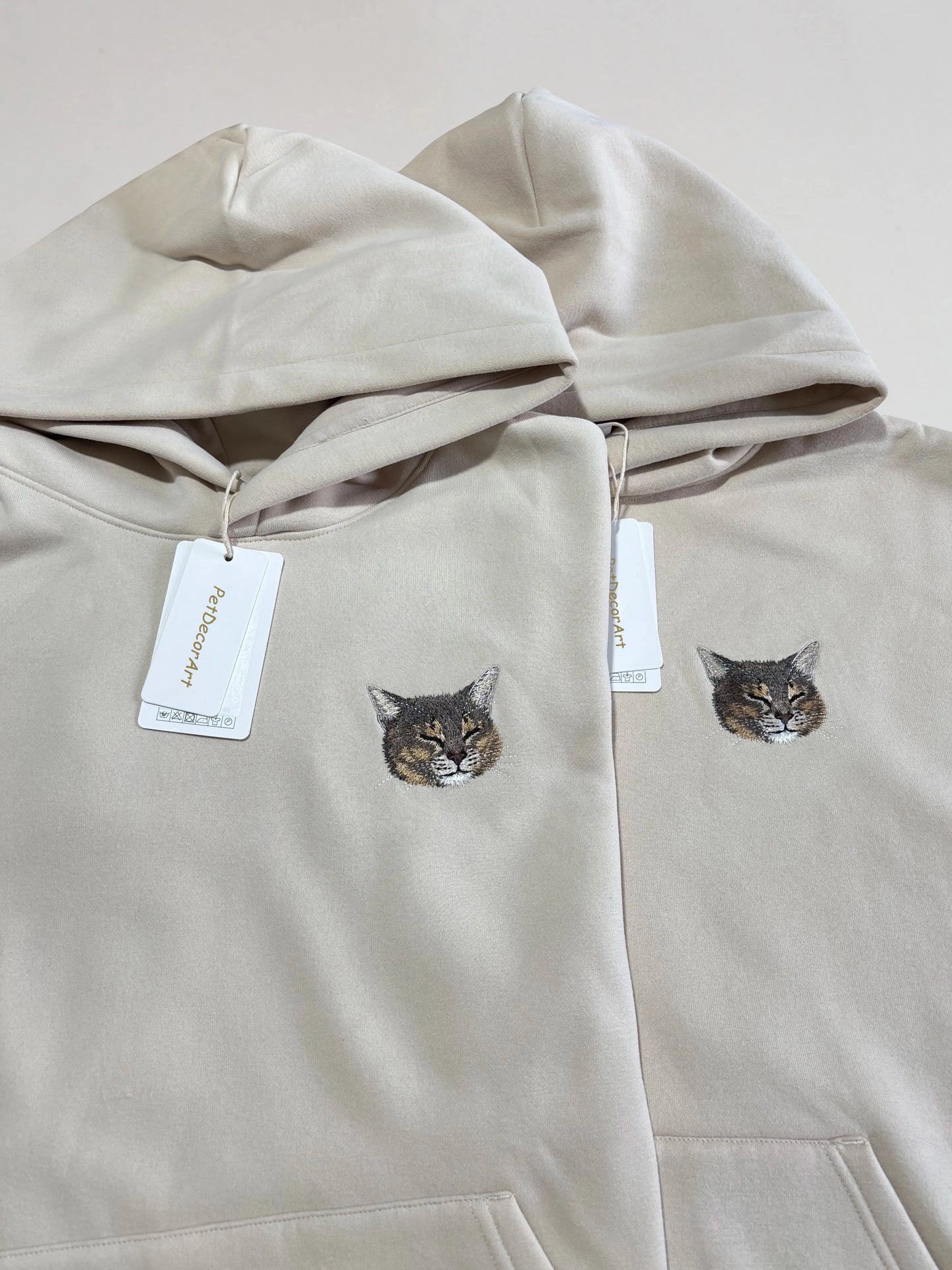 Custom embroidered pet portrait long sleeve hoodie from PetDecorArt showing detailed stitched pet faces