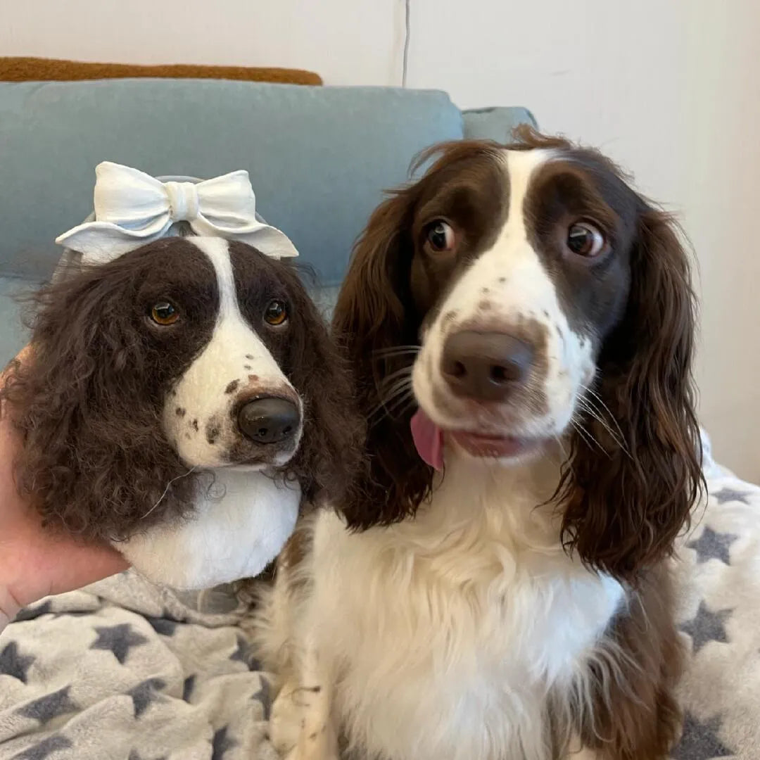 Dog with a lifelike wool-felt portrait—gentle, handmade keepsake.