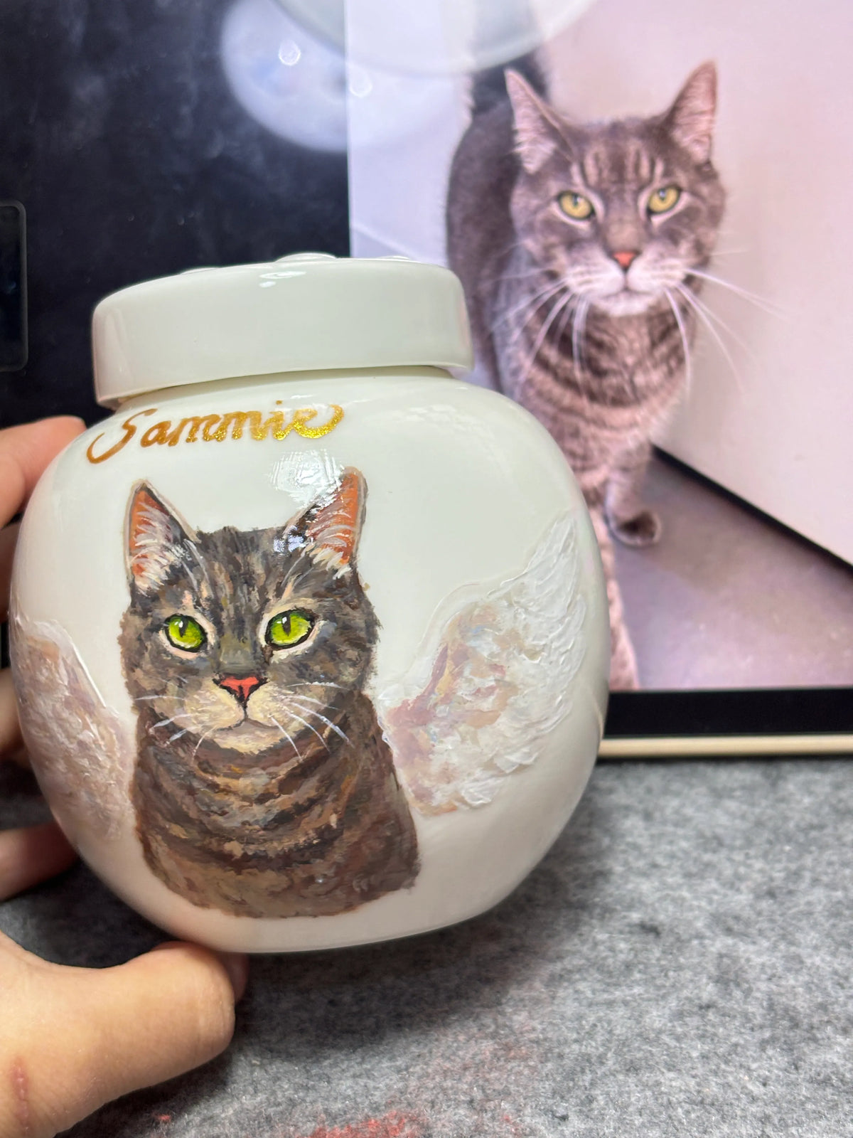 Paw print ceramic pet urn with a custom hand-painted cat portrait